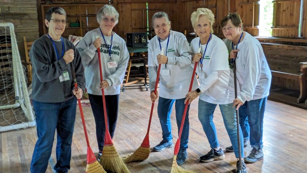 Alumnae are sweeping the Wigwam during Service Learning Weekend.